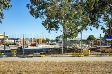 Australian school campus under construction, viewed behind a temporary safety fence—featuring infrastructure development, educational planning, and suburban community growth. © Doublelee