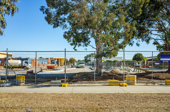 Australian school campus under construction, viewed behind a temporary safety fence&mdash;featuring infrastructure development, educational planning, and suburban community growth.