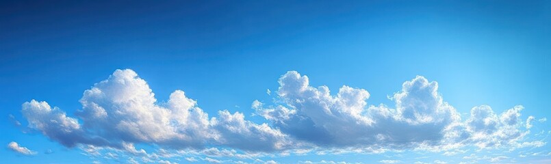 Bright blue sky filled with fluffy white clouds creating a peaceful and uplifting atmosphere