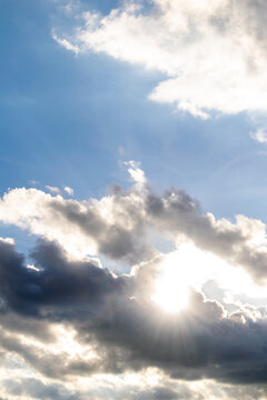 Sun between clouds, forming an abstract landscape