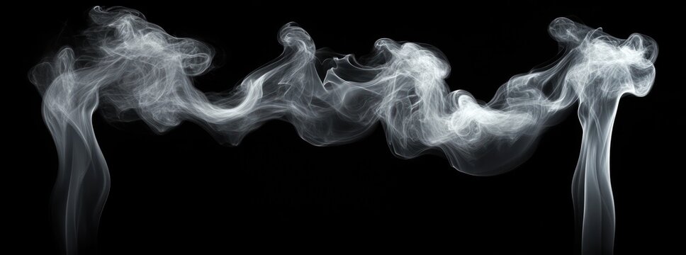 White smoke swirling and curling upwards against a black background creating abstract and flowing patterns