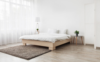Simple modern bedroom interior, contemporary minimalist design. Double bed with pillows and...