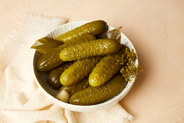 Marinated cucumbers in a bowl on a light background.