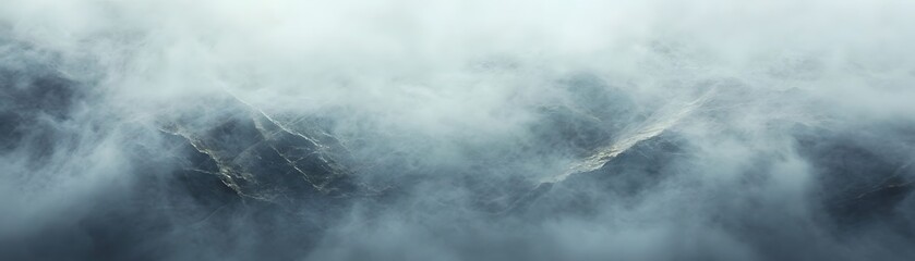 Obraz premium High-altitude view of a misty mountain range.
