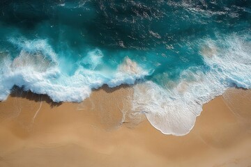 Aerial view of turquoise ocean waves crashing and foaming onto a clean sandy beach under bright sunlight