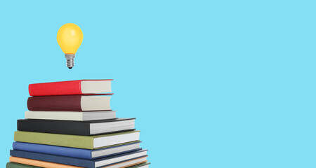 Idea and knowledge. Light bulb in air over stack of books on light blue background, space for text....