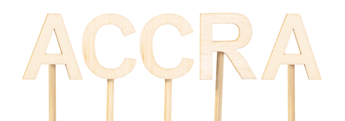 Accra, capital of Ghana, written in large letters in light wood on white background, minimalist and educational style