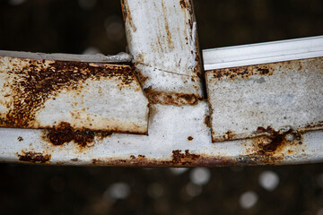 rusty metal ladder on a gray background, closeup of photo