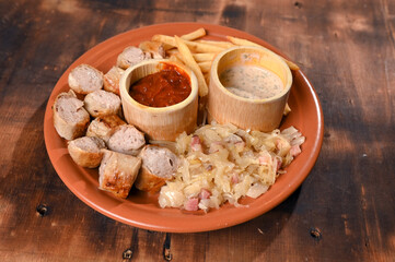 plate for food French fries sausage white sausage and sauerkraut herb sauce and ketchup typical German food taste