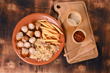plate for food French fries sausage white sausage and sauerkraut herb sauce and ketchup typical German food taste