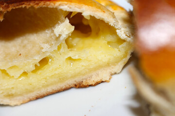 Cheese Empanada: Cut Open. Close-up: Cheese Interior of a Savory Empanada. Traditional Baked Pastry: Half Empanada with Cheese. Cheese Empanada Filling with selective focus.