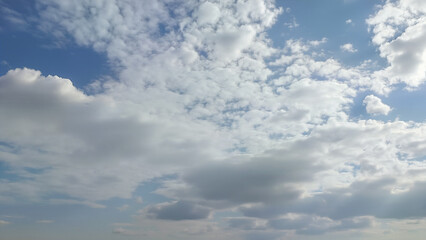 Isolated bright white clouds on clear blue sky. Perfect for backgrounds, weather concepts, or nature-themed projects.