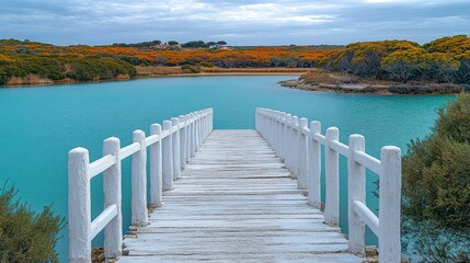 Obraz premium Tranquil wooden pier over turquoise water, leading to serene landscape