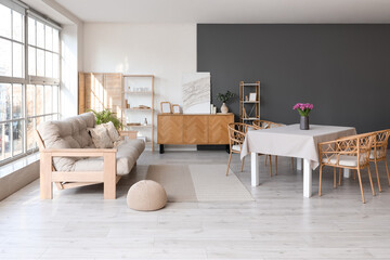 Interior of room with dining table and sofa