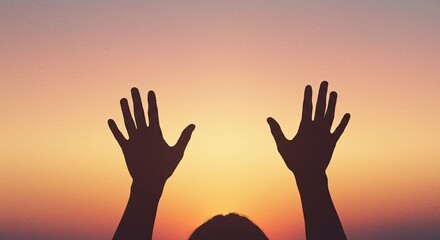 Against the soft gradient sky, a person's silhouette raises their open hands in gesture of prayer, hope, or perhaps sur to beautiful dusk.religion mood