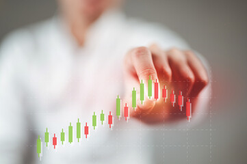 A businessman in a white shirt is tapping on an uptrend stock chart, causing the stock to fall.