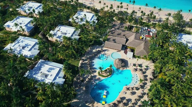 Flight around a tourist swimming pool located at an all-inclusive hotel