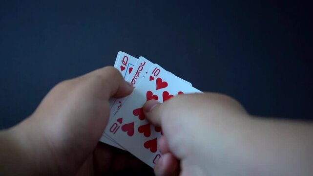 Close-up video showing the perfect poker hand: a royal straight flush laid out on the table. Ace-high hearts in a clean, dramatic reveal &ndash; the ultimate winning combination.