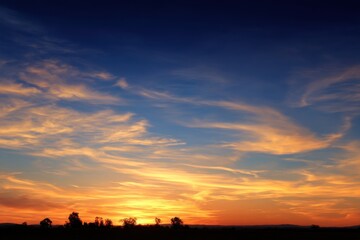 Obraz premium Fiery Sunset Sky with Silhouetted Trees Landscape View at Dusk in Rural Setting Dramatic Cloudscape