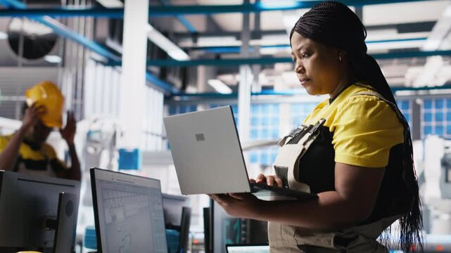 Photovoltaics factory technician designing CAD models and technical sketches for solar modules on laptop. Woman engineer ensures solar panel designs for efficiency and manufacturability. Camera A.