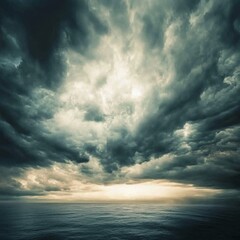 Fototapeta premium Dramatic clouds over ocean landscape wide angle shot with dark sky and sunlight breaking through horizon moody nature scene