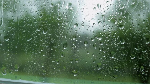 Slow Motion of Raindrops Running Down the Window