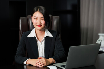 Asian business woman sitting in office