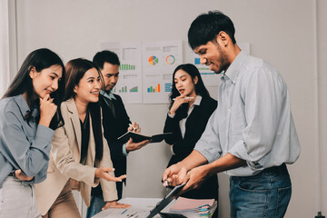Team of financial advisory services. Asian advisor showing plan of investment to clients in the consultancy office..