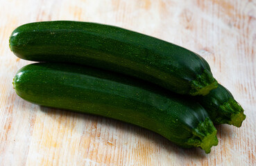 Organic zucchini on wooden cutting board. Healthy nutrition concept. High quality photo