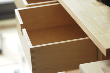 Wooden drawer partially open in a modern workspace