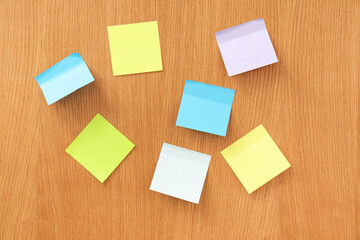 Different sticky notes on wooden background