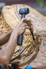 Wood carving tools. Carpenters hands use chisel hammer. Senior wood carving working with woodcarving instrument..