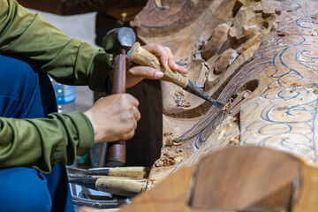 Wood carving tools. Carpenters hands use chisel hammer. Senior wood carving working with...