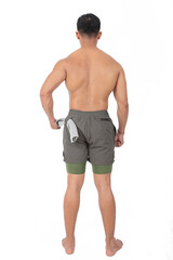 Fototapeta premium Young man wearing compression shorts with towel tucked in the back