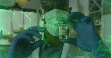 Male health worker holding syringe and vial in clinical lab, showing digital network overlay - Powered by Adobe