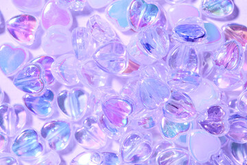 Texture of heart-shaped beads in water, top view