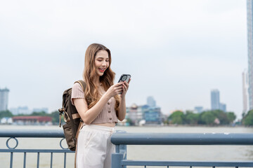 Fototapeta premium Asian young beautiful woman backpacker exploring the city outdoors.