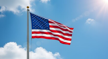 Fototapeta premium American Flag Flying on Pole Against Blue Sky National Flag of the USA in the Sky Patriotism National pride 