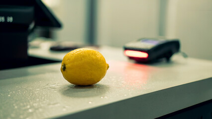 Fresh Lemon on Countertop at Checkout with Red Scanner Light