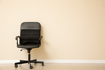 Office black chair near white wall in room