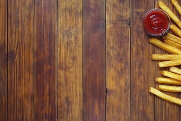 Fototapeta premium French Fries with Ketchup on Rustic Wood Table Still Life Top Down View Delicious Snack Meal Side Dish
