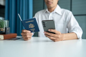 Hand Man Online booking and buying plane tickets using laptop phone and credit card Planning trip travel vacation with passport and ticket.