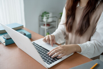 Asian woman working with laptop in living room