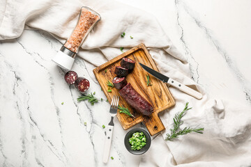 Composition with tasty blood sausage on white background