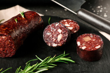 Tasty blood sausage on dark background, closeup