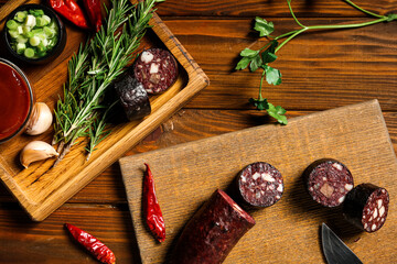 Composition with tasty blood sausage on wooden background