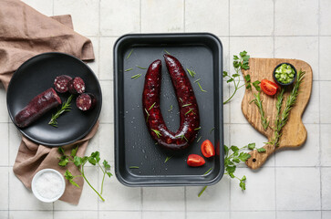 Composition with tasty blood sausage on white background