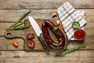 Composition with tasty blood sausage on wooden background