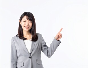 Smiling Japanese Businesswoman Pointing with Copy Space
