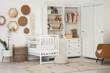 Interior of nursery with baby crib, closet and shelves